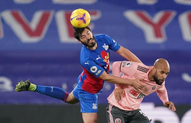 Crystal Palace's James Tomkins and Sheffield United's David McGoldrick vie for possession 