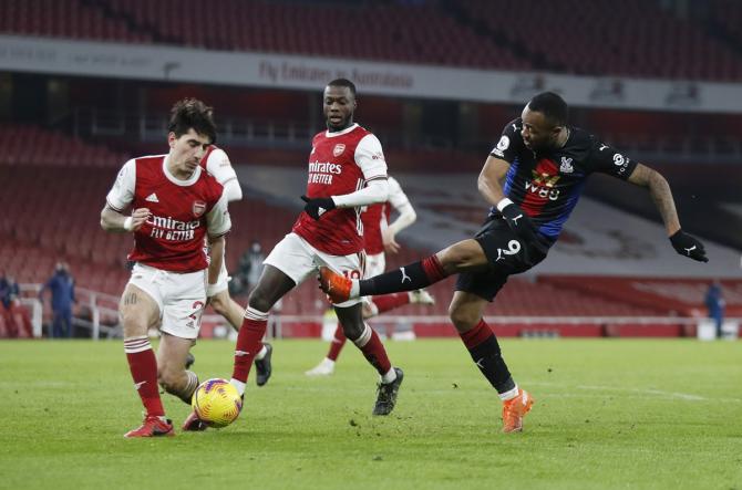 Arsenal's Hector Bellerin challenges Crystal Palace's Jordan Ayew during their Premier League match