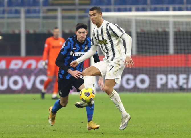 Cristiano Ronaldo, who was reduced to speculative efforts from distance, tries to get past  Alessandro Bastoni.