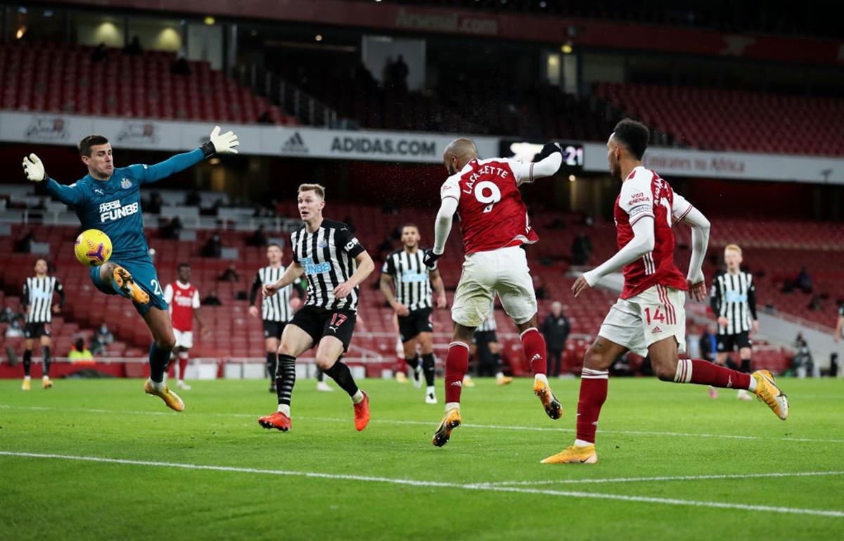 Newcastle United goalkeeper Karl Darlow saves off Alexandre Lacazette's header.