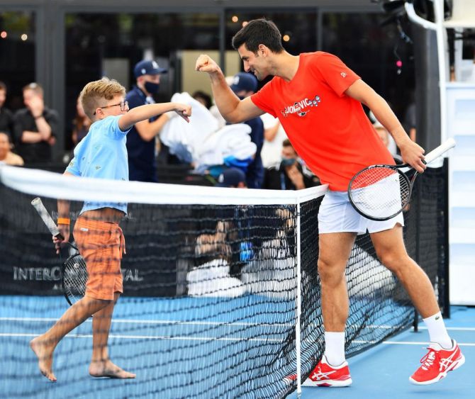 Novak Djokovic fist pumps a young fan he had a hit with during the 'A Day at the Drive' exhibition tournament at Memorial Drive in Adelaide, Australia, on Friday
