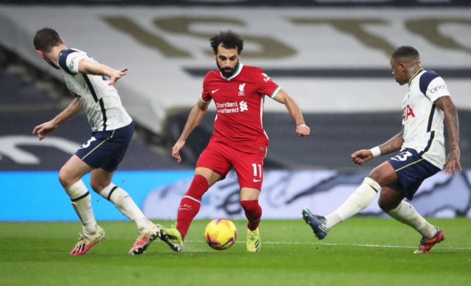 Liverpool's Mohamed Salah in action dribbles past Tottenham Hotspur's Steven Bergwijn
