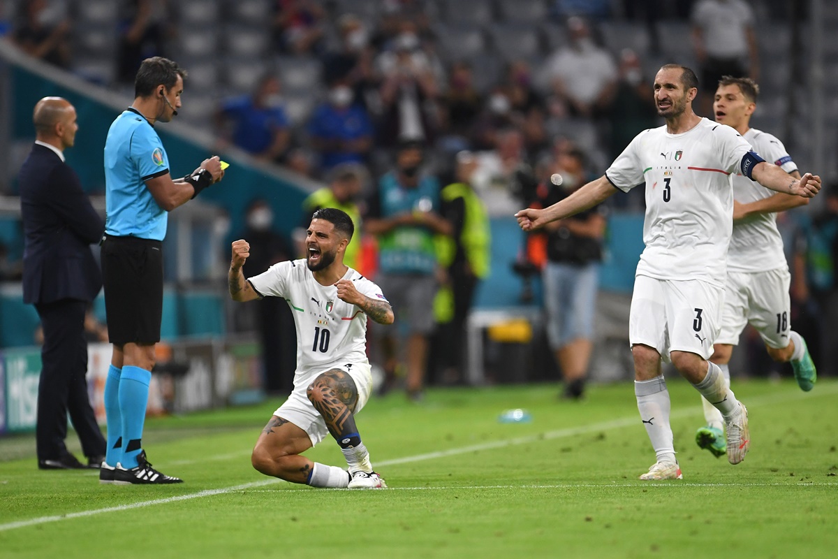 Lorenzo Insigne celebrates with teammates after scoring Italy's second goal.