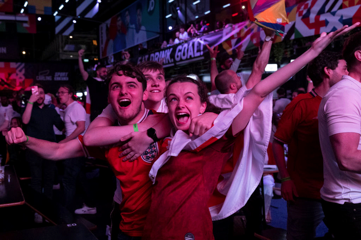 England fans cheer at BOXPARK Croydon as they watch a live broadcast of the semi-final match between England and Denmark