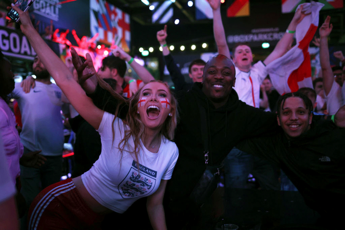 Fans celebrate in London after England's 2-1 win over Denmark in the Euro 2020 semi-final on Wednesday