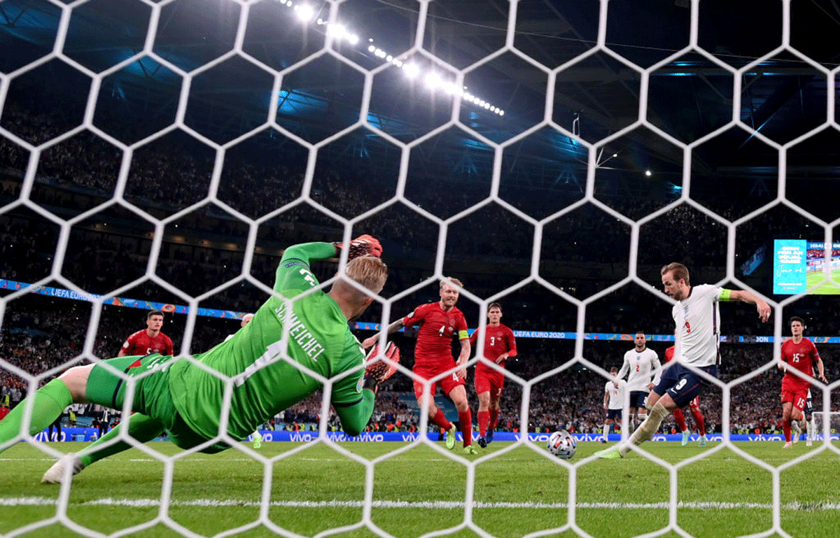 England's Harry Kane scores past Denmark's Kasper Schmeichel from the rebound of a saved penalty for their team's second goal during their UEFA Euro 2020 Championship semi-final at Wembley Stadium in London on Wednesday
