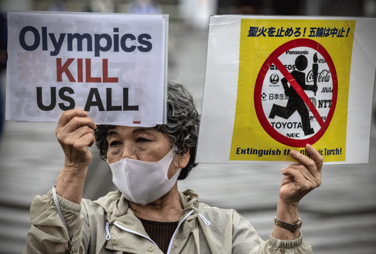 Anti-Olympics protesters demonstrate during an unveiling ceremony for the Tokyo leg of the Olympic torch relay in Komazawa Olympic Stadium