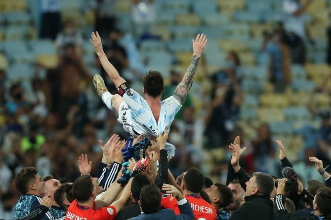 Lionel Messi is hoisted by his Argentina teammates after the final whistle.