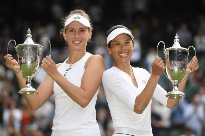 Taiwan's Hsieh Su-wei, right, and Belgium's Elise Mertens celebrate with the trophies after winning the Wimbledon women's doubles final against Russia's Elena Vesnina and Veronika Kudermetova.