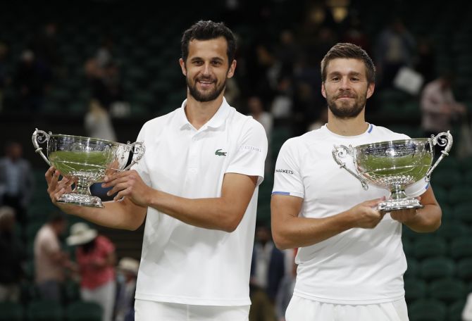 Croatia's Mate Pavic and Nikola Mektic celebrate with the trophies after defeating Spain's Marcel Granollers and Argentina's Horacio and winning the men's doubles final at Wimbledon on Saturday.