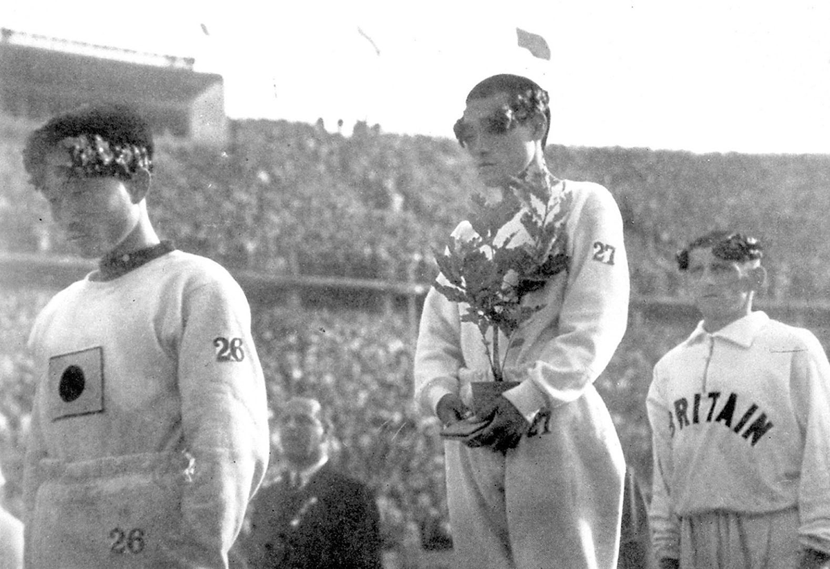 The gold medallist for a marathon at the 1936 Berlin Olympic Games, Sohn Kee-chung stands on the podium with his head lowered instead of looking at Japan's rising-sun flag in this photo taken in Berlin, 1936