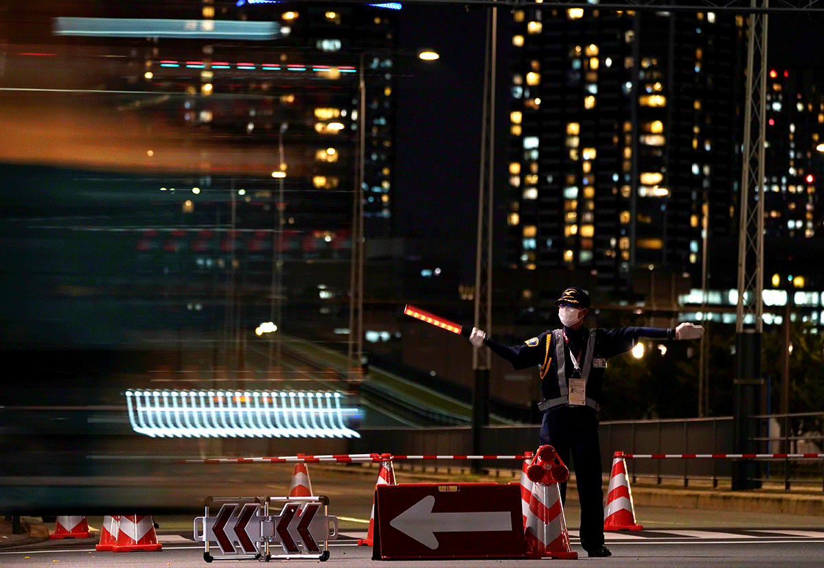 A security officer stands guard near the 2020 Tokyo Olympic Games Athletes' Village in Tokyo.