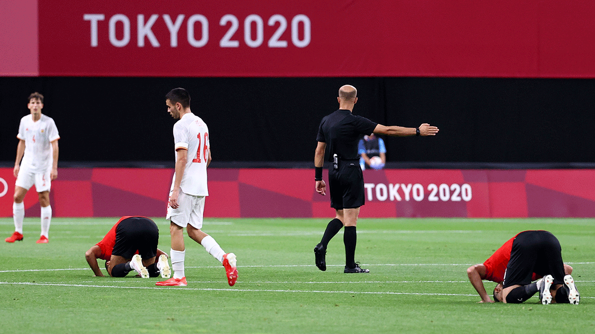  Egypt players pray at the end of the match as Spain's Pedri looks dejected after a stalemate in their Tokyyo Olympics Group C match at Sapporo Dome in Sapporo, Japan, on Thursday 