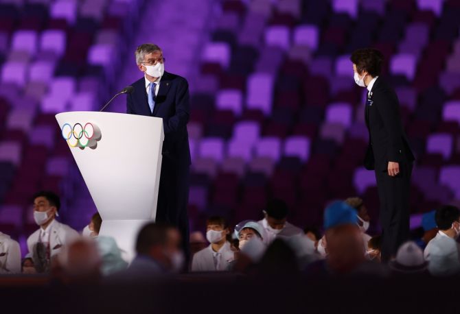 International Olympic Committee President Thomas Bach, wearing a protective face mask, looks toward Tokyo 2020 President Seiko Hashimoto during his speech at the Olympics 2020 opening ceremony.
