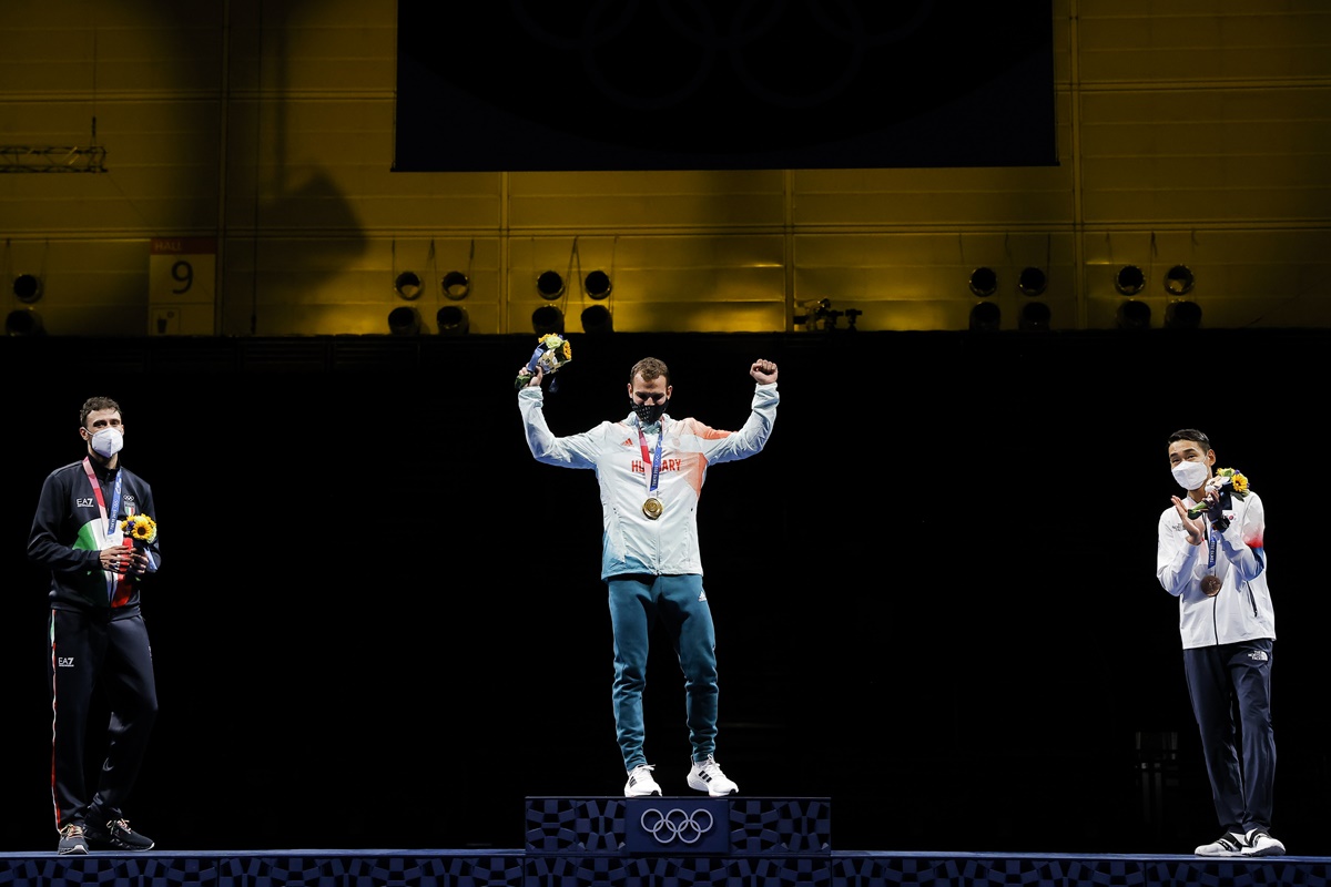 Gold medallist Aron Szilagyi of Hungary celebrates on the podium with silver medallist Luigi Samele of Italy and bronze medallist Kim Jung-Hwan of South Korea after the men's Individual Sabre medal ceremony.