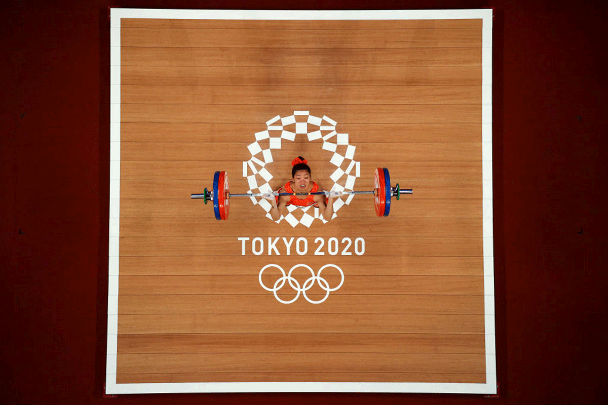 Mirabai Chanu competes during the Weightlifting Women's 49kg Group A on day one of the Tokyo 2020 Olympic Games at Tokyo International Forum in Tokyo on Saturday