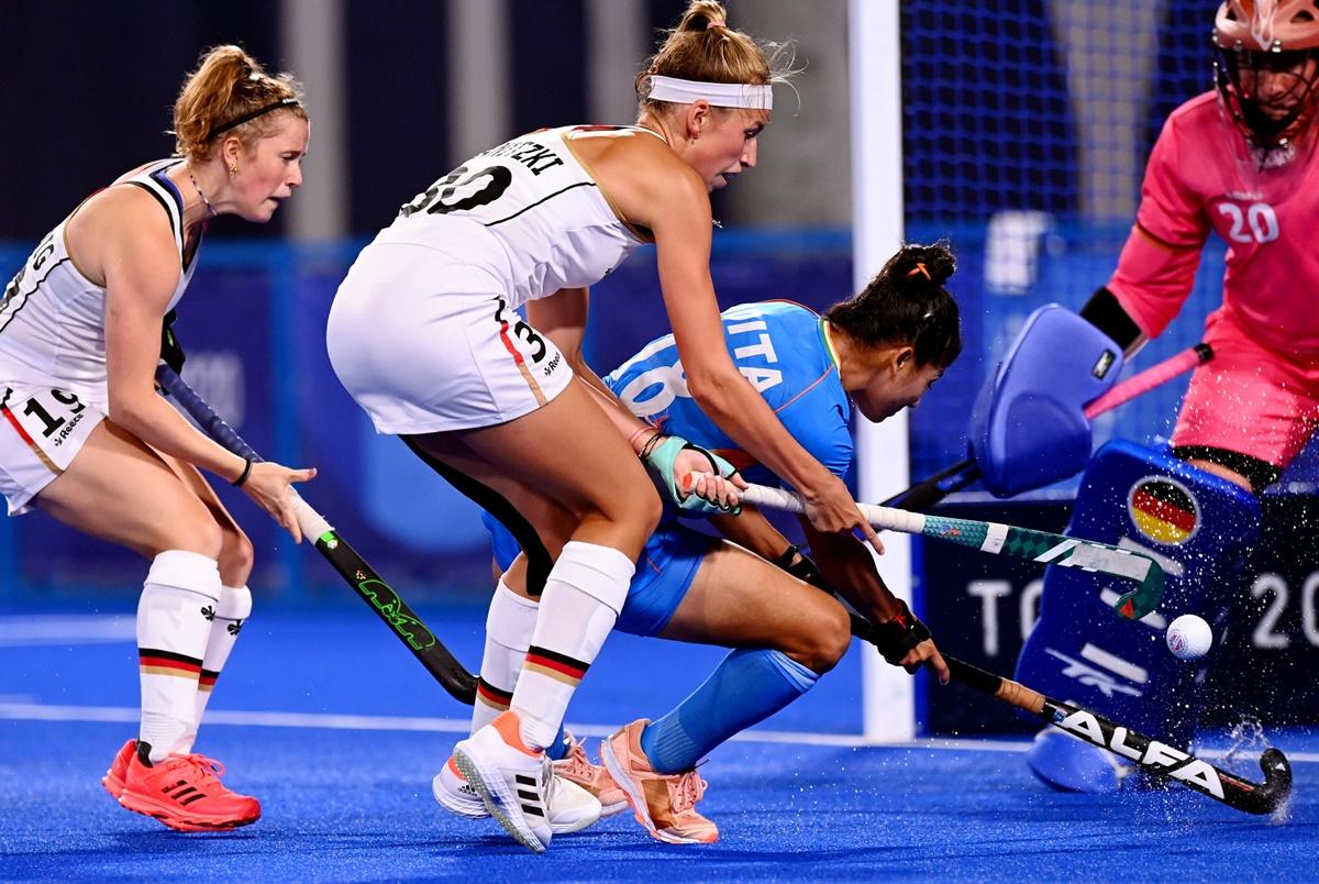 Germany's goalkeeper Julia Sonntag watches as India's Udita fails to connect the ball home.