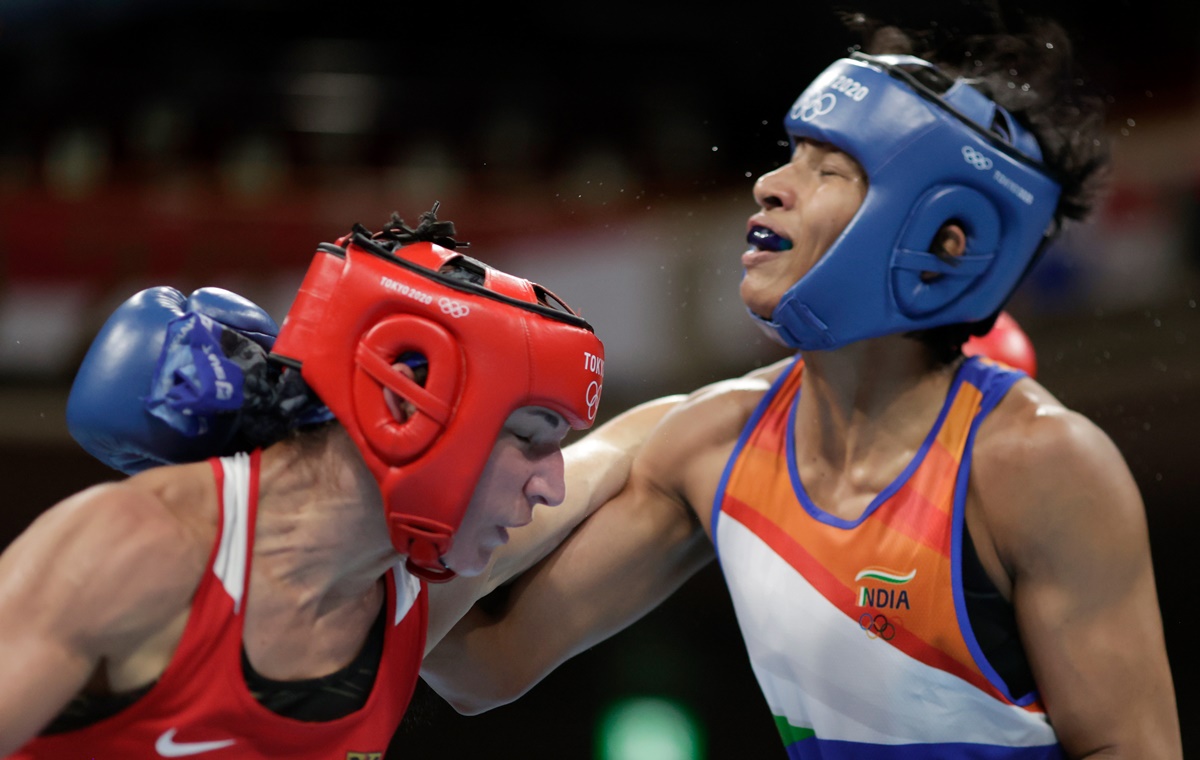 India's Lovlina Borgohain evades a punch from Germany's Nadine Apetz (red) during the women's welterweight (64-69kg) bout, at Kokugikan Arena in Tokyo, on Tuesday. 