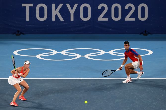 Serbia's Novak Djokovic and Nina Stojanovic in action against Brazil's Marcelo Melo and Luisa Stefani during their Olympics mixed doubles first round match