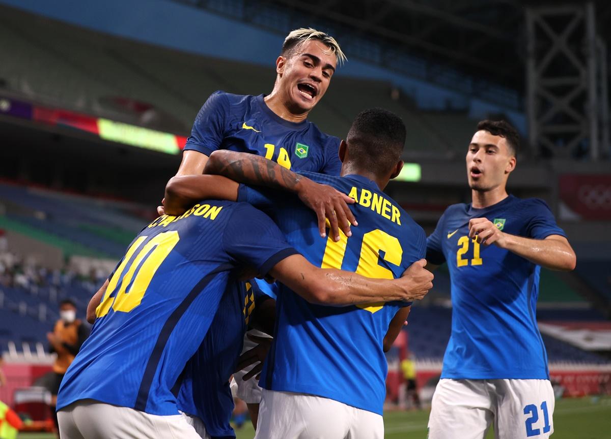 Richarlison celebrates with teammates after scoring Brazil's third goal in the men's Group D Olympics football match against  Saudi Arabia, at Saitama stadium, in Saitama, Japan, on Wednesday.