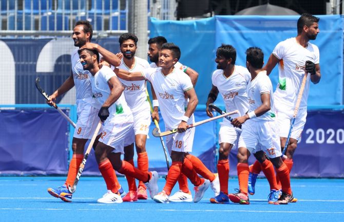 India's Varun Kumar celebrates with teammates after scoring the opening goal in the men's Olympics match against Argentina on Thursday.