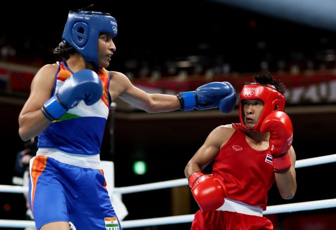 India's  Simranjit Kaur exchanges punches with Thailand's Sudaporn Seesondee (red) during the Olympics women's lightweight (57-60kg) boxing bout, at Kokugikan Arena in Tokyo, on Friday.