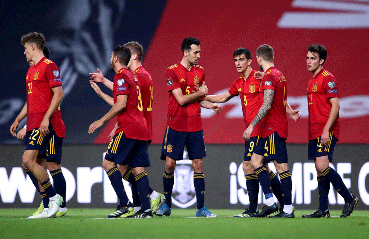 Spain's Gerard Moreno of Spain celebrates with teammates Sergio Busquets and Inigo Martinez after scoring. Spain's squad is bursting with talent and experience, even without 35-year-old Ramos, but it lacks a bit of cohesion.