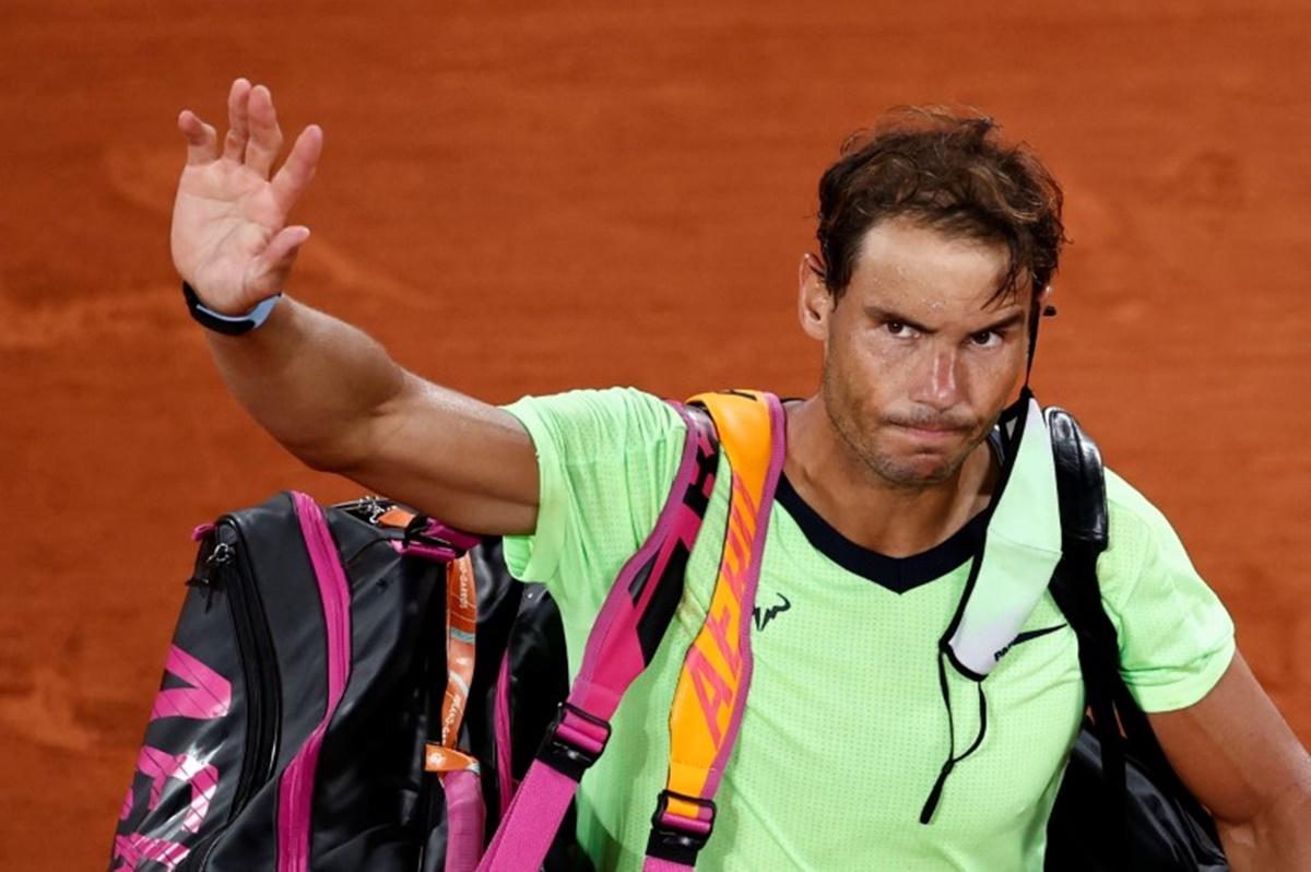 Rafael Nadal waves to the crowd as he leaves the court