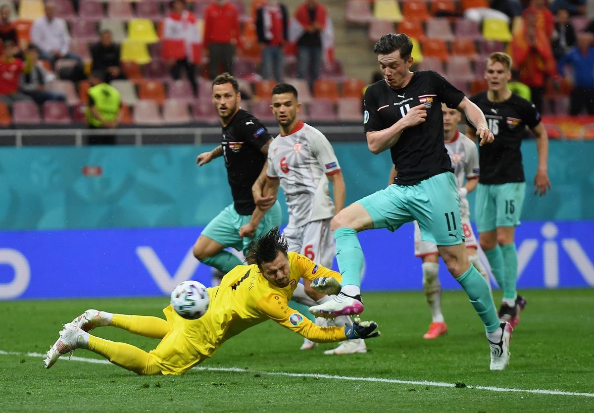 Michael Gregoritsch scores Austria's second goal past Stole Dimitrievski. 