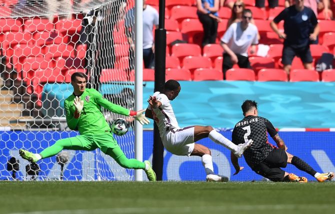 England's Raheem Sterling places the ball past Croatia goalkeeper Dominik Livakovic