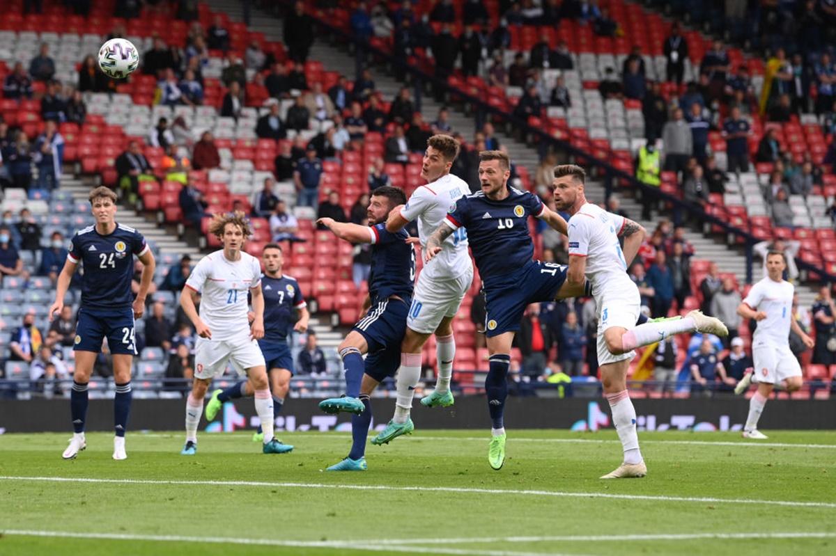 Patrik Schick scores the Czech Republic's first goal with a header whilet under pressure from Liam Scotland's Cooper. 