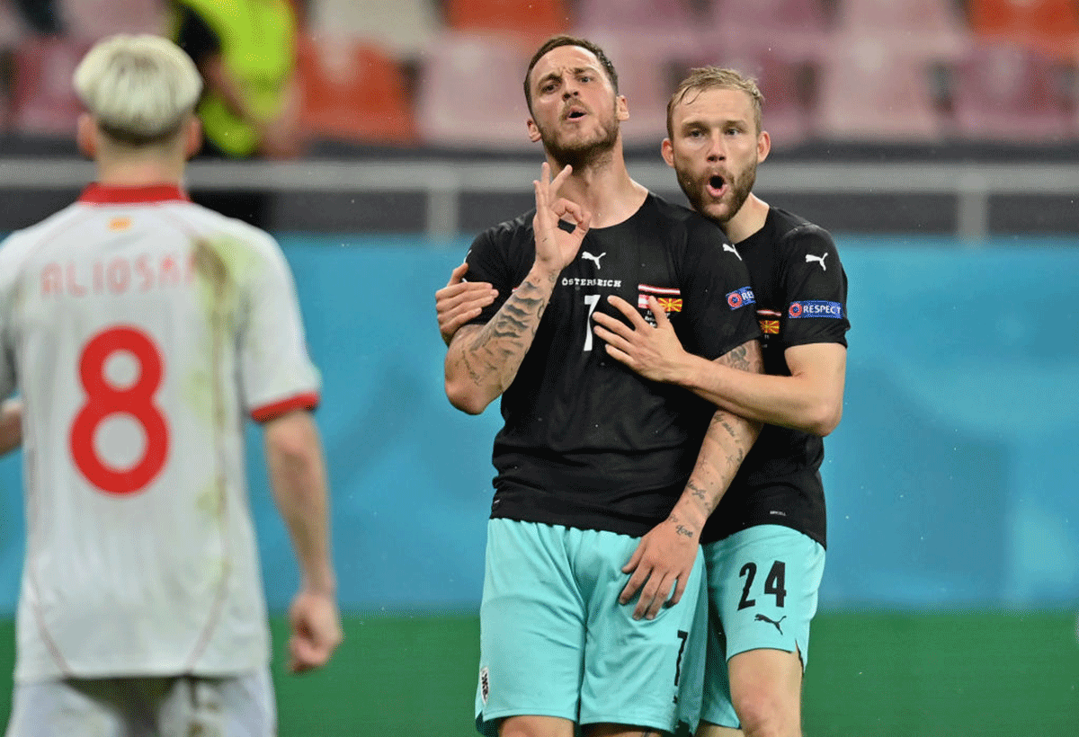 Austria's Marko Arnautovic gestures towards North Macedonia's Gianni Alioski as he celebrates a goal with teammate Konrad Laimer after scoring during the UEFA Euro 2020 Championship Group C match at National Arena Bucharest in Bucharest, Romania, on Sunday