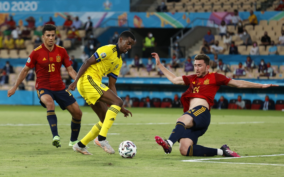 Sweden's Alexander Isak is challenged by Spain's Aymeric Laporte.