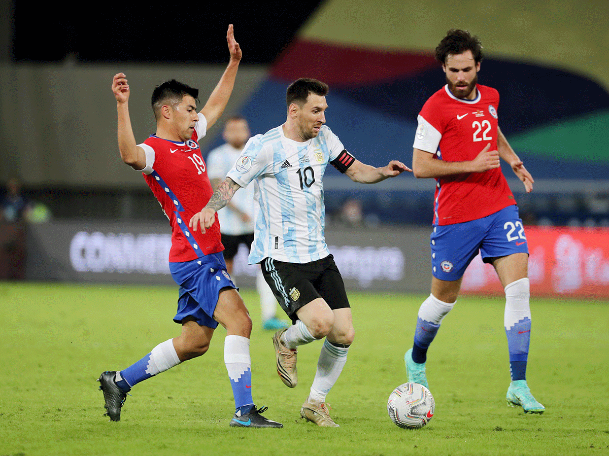 Argentina's Lionel Messi is challenged by Chile's Tomas Alarcon during their Copa America Group A match on Monday