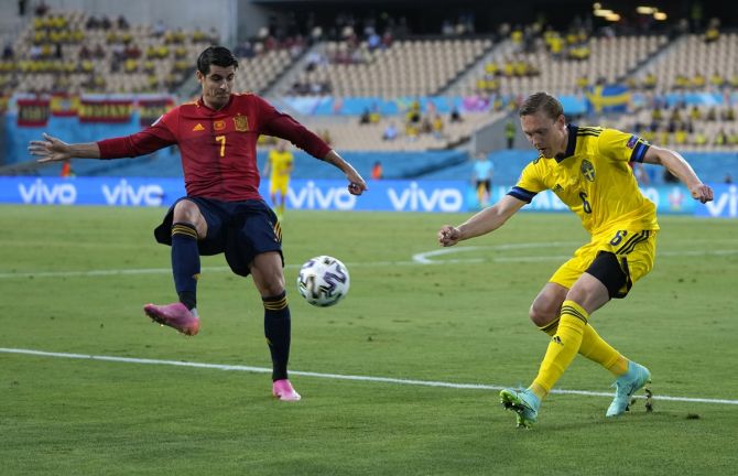 Sweden's Ludwig Augustinsson clears the ball while under pressure from Spain's Alvaro Morata during the Euro 2020 Group E match, at the La Cartuja stadium in Seville, Spain, on Monday. 