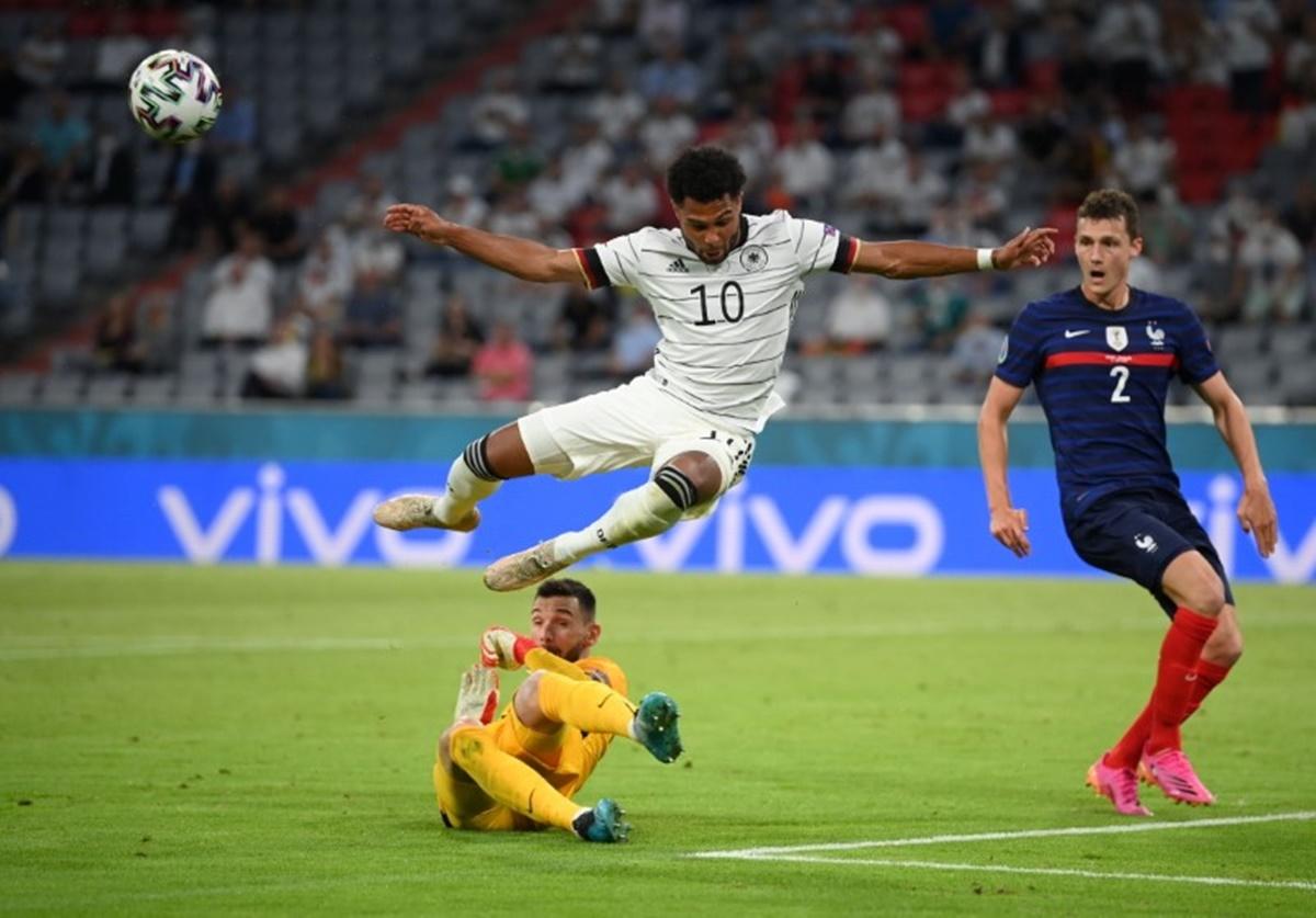 France goalkeeper Hugo Lloris thwarts Germany's Serge Gnabry.