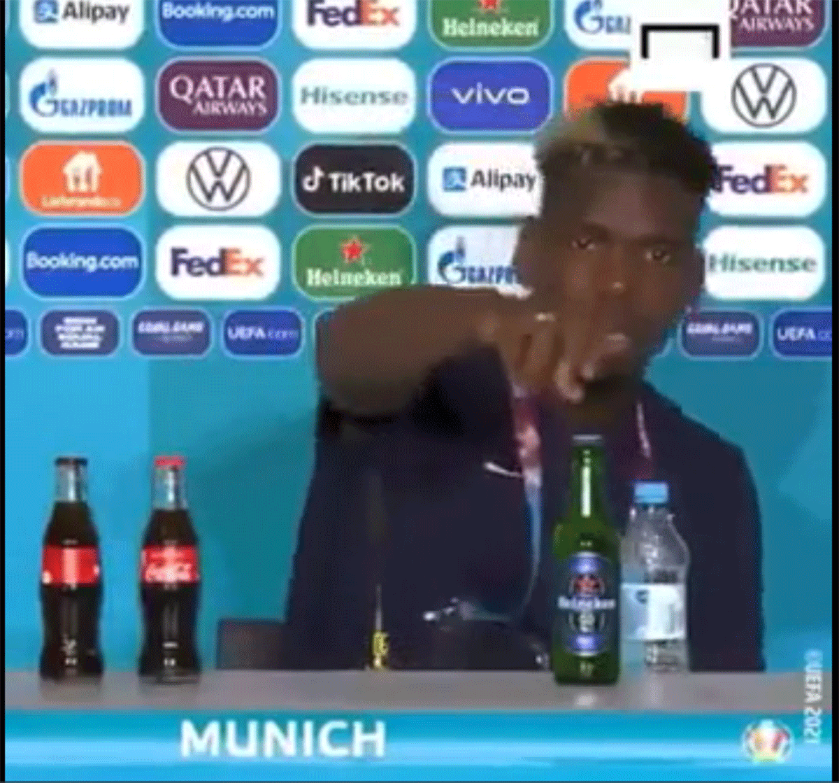Paul Pogba takes out the bottle of Heineken beer from the table at the post-match press conference at Euro 2020