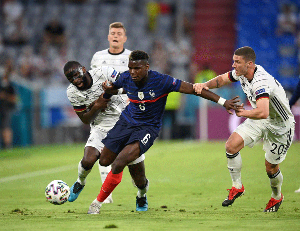 France's Paul Pogba battles for possession with Germany's Antonio Ruediger and Robin Gosens