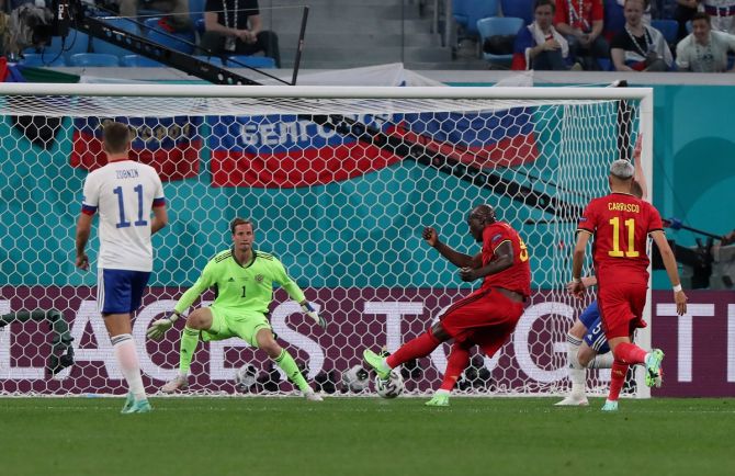 Belgium's Romelu Lukaku scores their first goal past Russia'S Mario Fernandes.