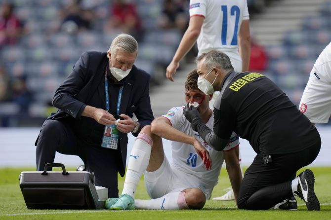 Patrik Schick receives medical treatment after sustaining an injury, which led to the penalty