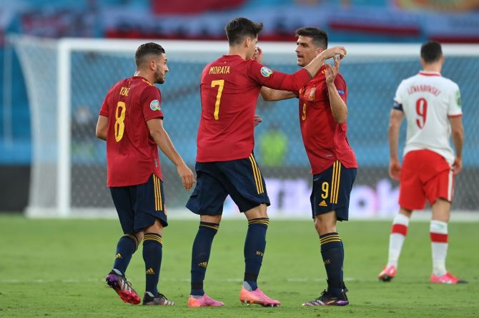 Alvaro Morata celebrates with Koke and Gerard Moreno after putting Spain ahead
