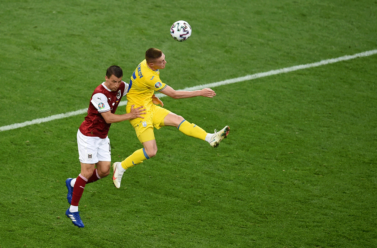 Ukraine's Viktor Tsygankov in action with Austria's Stefan Lainer during their Group C match