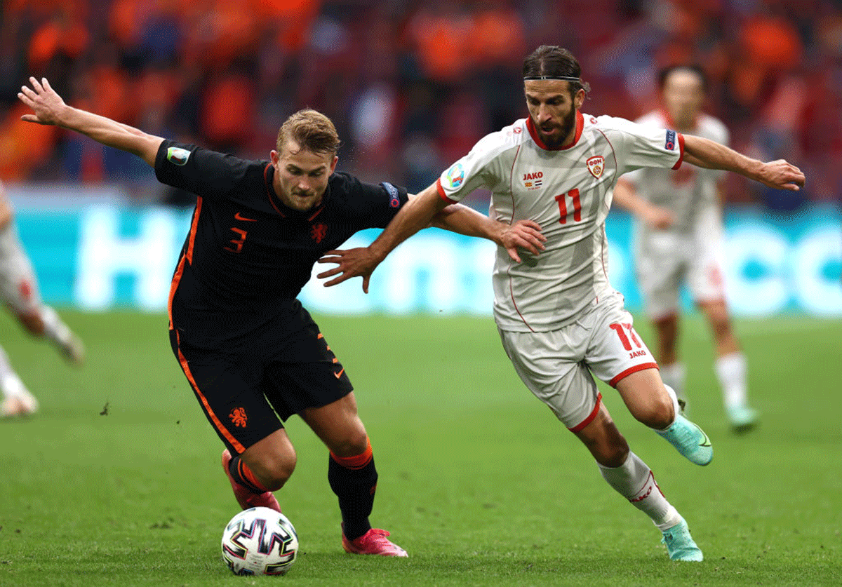 Netherlands' Matthijs de Ligt battles for possession with North Macedonia's Feran Hasani