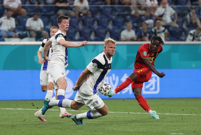 Belgium's Jeremy Doku essays a shot at goal while challenged by Finland's Paulus Arajuuri.