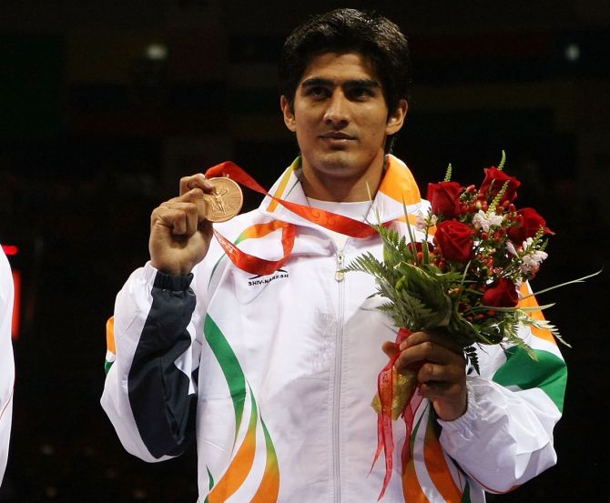 India's Vijender Singh poses on the podium during the medal ceremony for the men's middleweight (75kg) final bout, at the Beijing 2008 Olympic Games on August 23, 2008. 