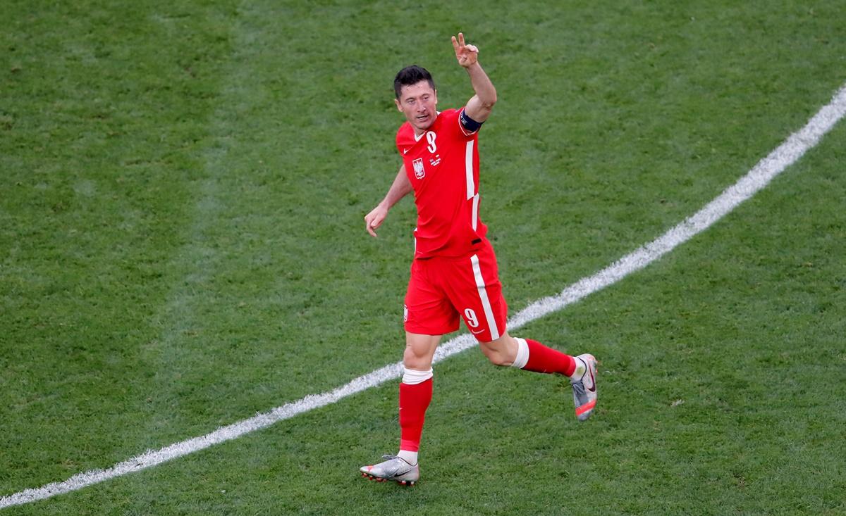 Robert Lewandowski celebrates pulling a goal back for Poland and reducing the margin to 1-2.