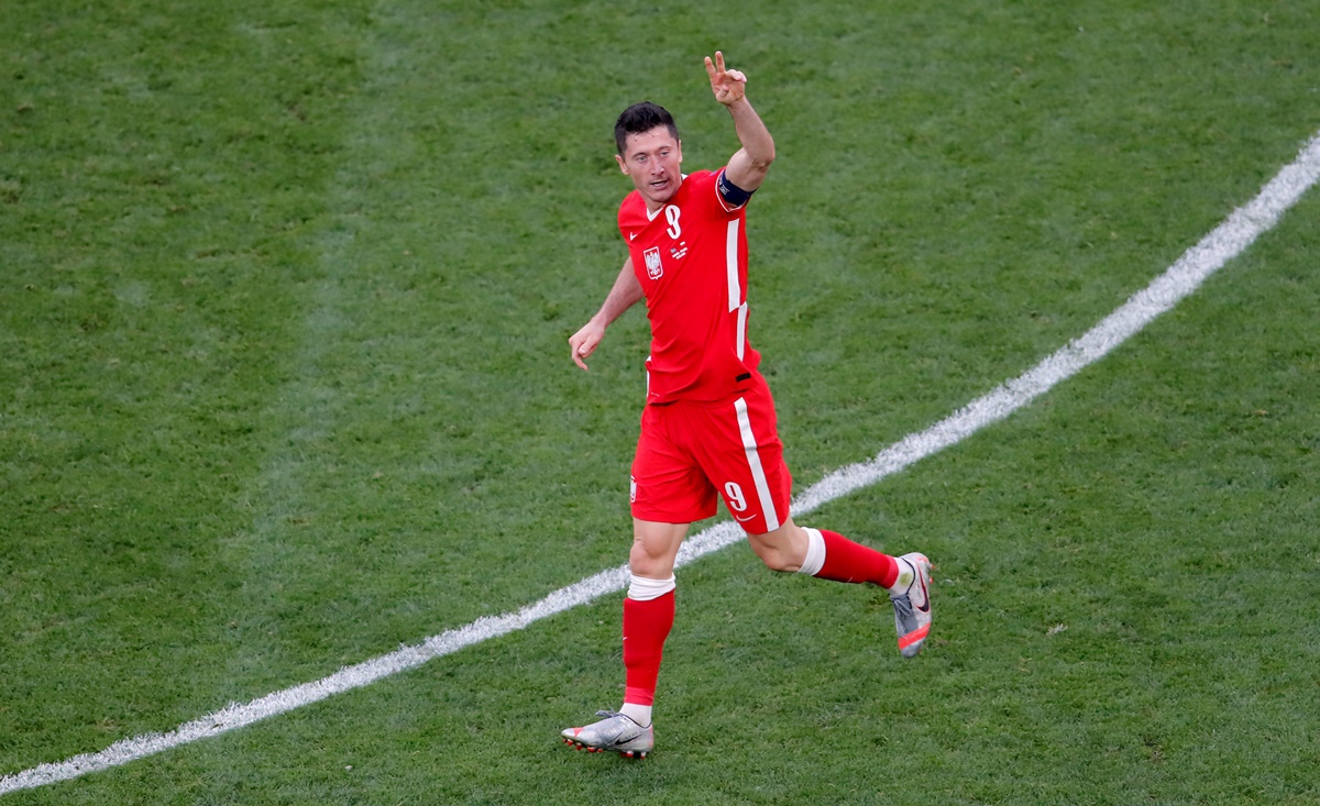 Robert Lewandowski celebrates pulling a goal back for Poland and reducing the margin to 1-2.