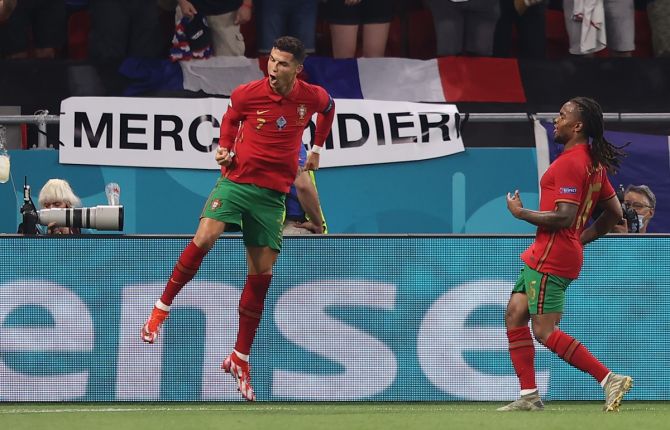 Cristiano Ronaldo celebrates with teammate Renato Sanches after scoring Portugal's second goal from the penalty spot.