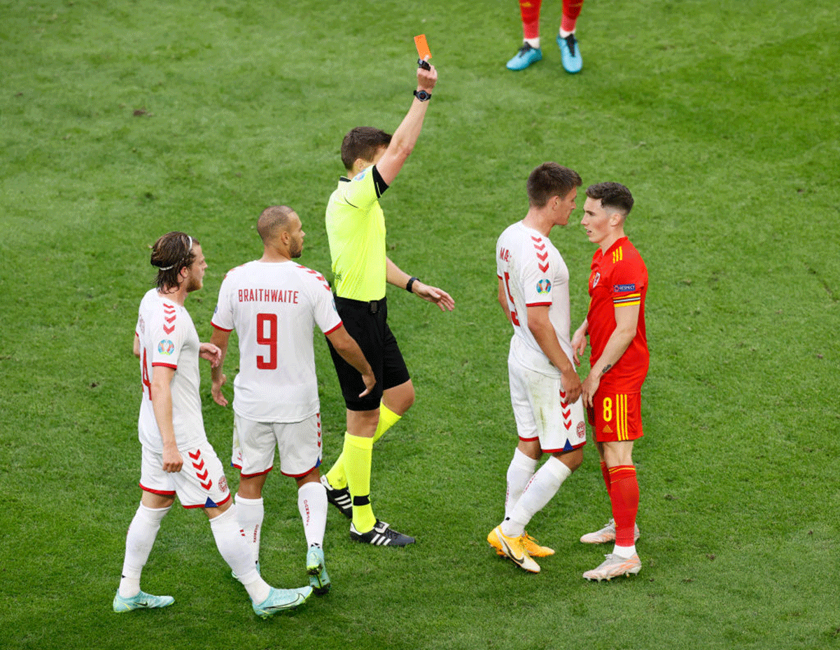 Wales' Harry Wilson is shown a red card by referee Daniel Siebert