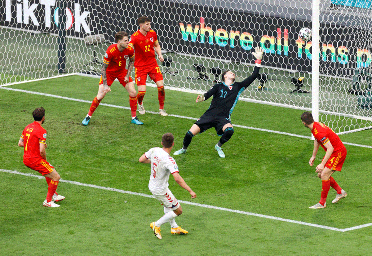 Denmark's Joakim Maehle scores their side's third goal past Wales' Danny Ward